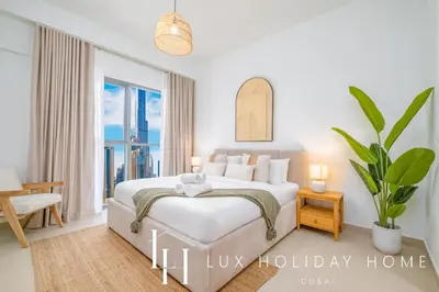a bedroom with a bed and a large window at LUX The Executive Burj Khalifa View Suite 2 in Dubai
