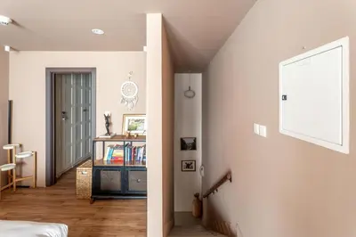 a hallway with a white wall and a stair case at GuestReady - Modern urban retreat in JLT in Dubai