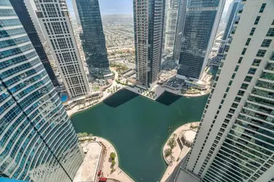 an aerial view of a river between two tall buildings at GuestReady - Modern urban retreat in JLT in Dubai
