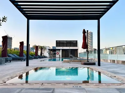 a swimming pool on the roof of a building at Peaceful 2 Bed Oasis Suite in JVC in Dubai