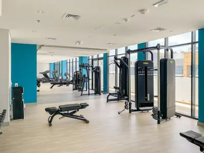 a gym with several treadmills and exercise bikes at Stunning Luxury Studio in Dubai in Dubai