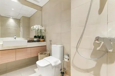a bathroom with a toilet and a sink and a shower at Stunning Luxury Studio in Dubai in Dubai