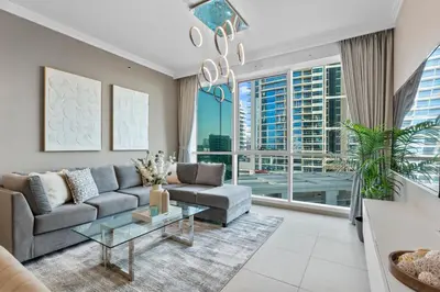 a living room with a couch and a table at Serene 2-bedroom Escape with Sea Steps Away in JBR in Dubai