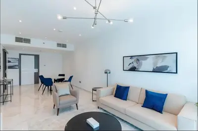 a living room with a couch and a table at AWS Holiday Homes - Style in Downtown in Dubai
