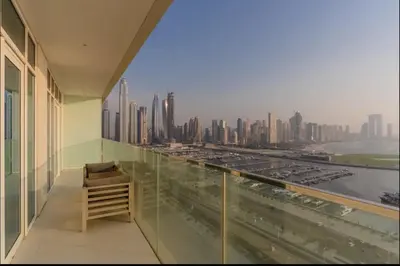 a balcony of a building with a view of a city at AWS Holiday Homes - Amazing Beachfront Stay in Dubai