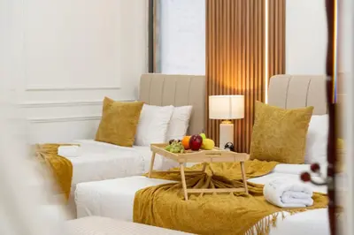 a room with two beds and a table with fruit on it at Dubai Eye & Sea View 2BR Marina & Beach Walk in Dubai