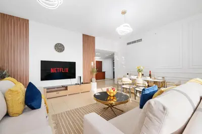 a living room with a couch and a tv at Dubai Eye & Sea View 2BR Marina & Beach Walk in Dubai