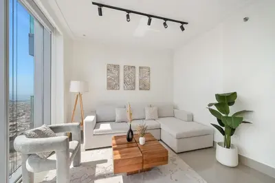 a living room with a couch and a table at FIRST CLASS 1BR Modern Luxury on High Floor in Dubai