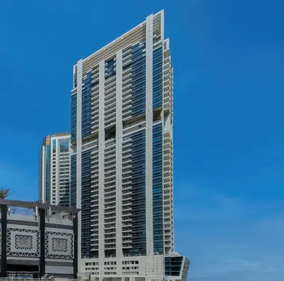 a tall building with a blue sky in the background at Elegant 1 Bedroom in Botanica Tower Marina in Dubai