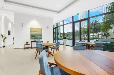 a dining room with tables and chairs and large windows at Burj Khalifa & Fountain From Your Balcony Near Dubai Mall & Metro in Dubai