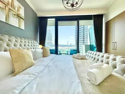 a bedroom with a large white bed with a large window at Burj Khalifa & Fountain From Your Balcony Near Dubai Mall & Metro in Dubai