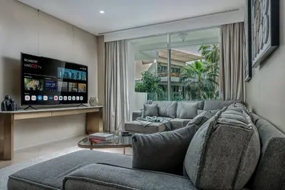 a living room with a couch and a tv at FIVE Palm Jumeirah Premier Apartments in Dubai