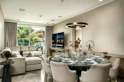a living room with a table and chairs and a couch at FIVE Palm Jumeirah Premier Apartments in Dubai