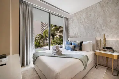 a bedroom with a large bed and a large window at FIVE Palm Jumeirah Premier Apartments in Dubai