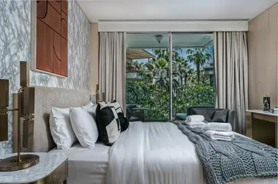 a bedroom with a bed and a large window at FIVE Palm Jumeirah Premier Apartments in Dubai