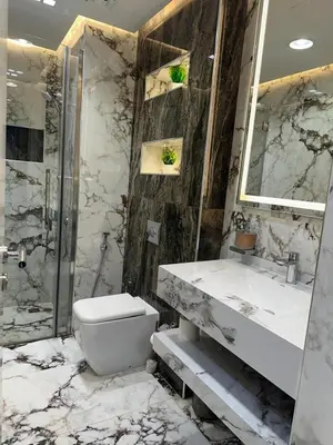 a bathroom with a toilet and a sink and a shower at Designer 1BR I Golf View I Comfortably Sleeps 4 in Dubai