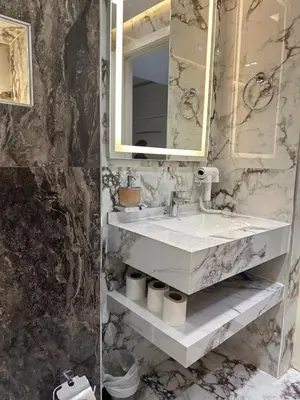 a bathroom with a sink and a mirror at Designer 1BR I Golf View I Comfortably Sleeps 4 in Dubai