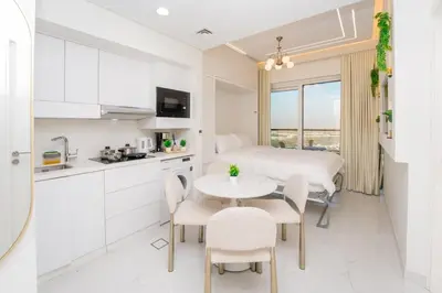 a kitchen and dining room with a table and chairs at Designer 1BR I Golf View I Comfortably Sleeps 4 in Dubai