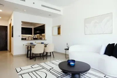 a living room with a white couch and a table at FULL Burj Khalifa View Luxury Stay in Downtown in Dubai