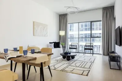 a living room with a table and chairs and a couch at FULL Burj Khalifa View Luxury Stay in Downtown in Dubai