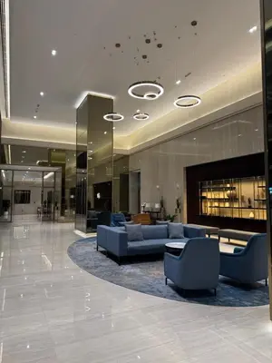 a lobby with couches and a fireplace in a building at FULL Burj Khalifa View Luxury Stay in Downtown in Dubai