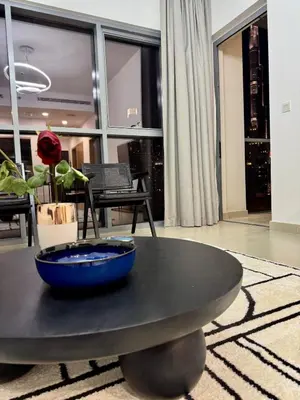 a blue bowl on a black table in a living room at FULL Burj Khalifa View Luxury Stay in Downtown in Dubai