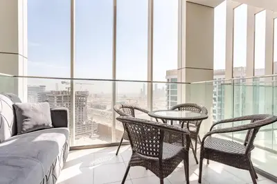 a bedroom with a bed and two chairs and a table at Studio Free Parking Pet Friendly Near Downtown Dubai in Dubai