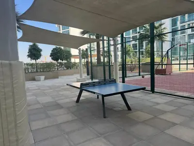 a ping pong table in a building with a tennis court at Studio Free Parking Pet Friendly Near Downtown Dubai in Dubai