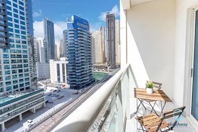 a balcony with a view of a city at Lovely Cozy Studio l Steps to JBR in Dubai