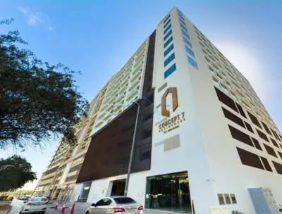 a building with the number on it at Pool View Studio with Balcony Close to Mall, Concept 7 Residences, Jumeirah Village Circle by Deluxe Holiday Homes in Dubai