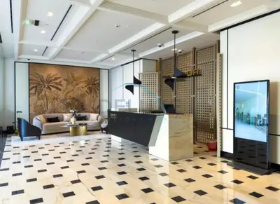 a lobby with a reception desk and a couch at Pool View Studio with Balcony Close to Mall, Concept 7 Residences, Jumeirah Village Circle by Deluxe Holiday Homes in Dubai