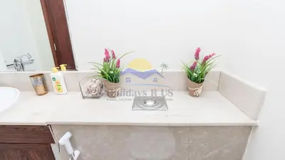 a bathroom counter with a sink and plants on it at Holidays R Us villa 4 bedroom boulevard view in Dubai