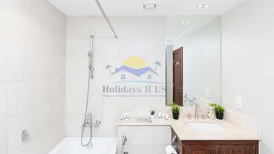a bathroom with a tub and a sink and a bath tub at Holidays R Us villa 4 bedroom boulevard view in Dubai
