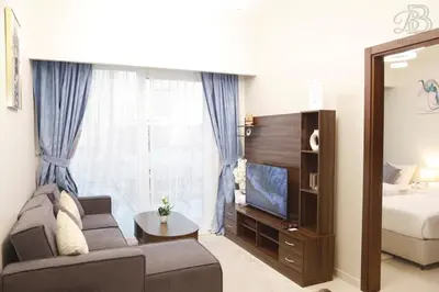a living room with a couch and a bed and a television at Stylish 2BR Apt in Business Bay Burj & Creek Views in Dubai