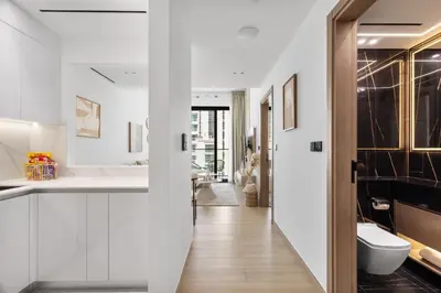 a white bathroom with a toilet and a sink at Modern 1BR Apartment - JVC - WiFi - Pool - Gym in Dubai