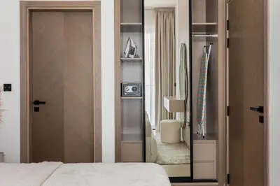 a bedroom with a door leading into a room at Modern 1BR Apartment - JVC - WiFi - Pool - Gym in Dubai