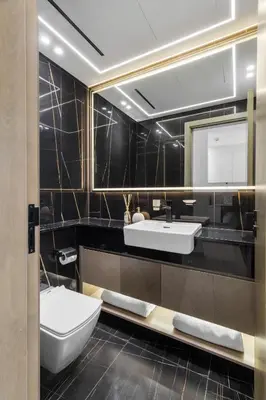 a bathroom with a sink and a toilet and a mirror at Modern 1BR Apartment - JVC - WiFi - Pool - Gym in Dubai