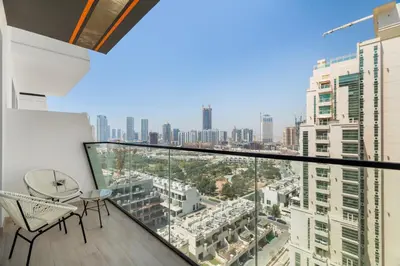 an apartment balcony with a view of the city at Modern 1BR Apartment - JVC - WiFi - Pool - Gym in Dubai