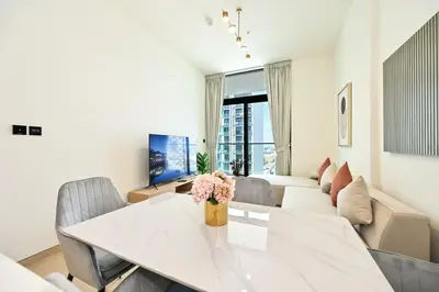 a living room with a table and a couch at Stunning 1 Bdr luxury residence at JVC in Dubai