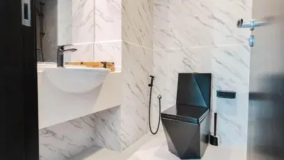 a bathroom with a toilet and a sink at Sky High 2BR Stay Amazing Marina Views Near Metro & Mall in Dubai