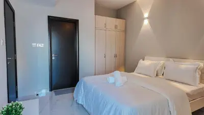 a bedroom with a large white bed with white pillows at Sky High 2BR Stay Amazing Marina Views Near Metro & Mall in Dubai