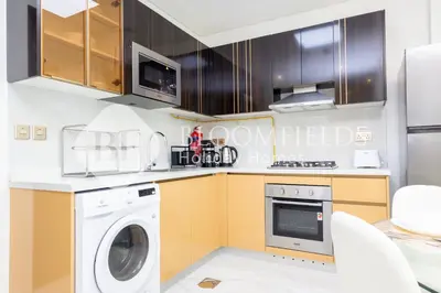 a kitchen with a washer and dryer at Bloomfields Hidden Gem 1Br with Private Pool in Dubai