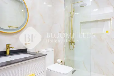 a bathroom with a shower and a toilet and a sink at Bloomfields Hidden Gem 1Br with Private Pool in Dubai