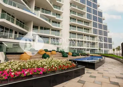 a large apartment building with flowers in front of it at Bloomfields Hidden Gem 1Br with Private Pool in Dubai