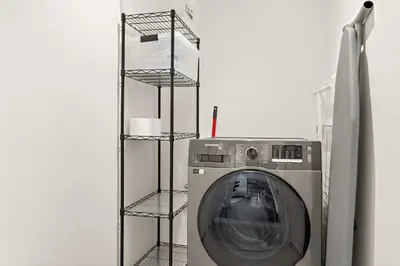 a washing machine on a shelf in a room at Silkhaus Chic 1BR in Creek Beach Grove with Pool view in Dubai
