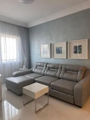 a living room with a couch and a table at Cozy 1BR, 2Min to Dubai Mall in Dubai