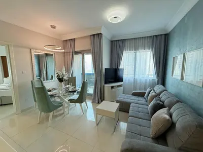 a living room with a couch and a table at Stylish 1BR, 2Min to Dubai Mall in Dubai