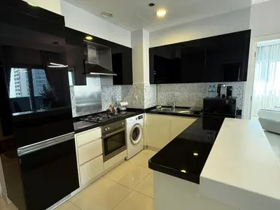 a kitchen with black and white cabinets and a dishwasher at Stylish 1BR, 2Min to Dubai Mall in Dubai