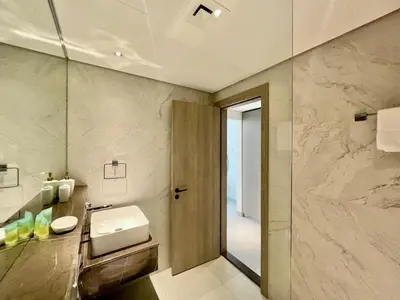a bathroom with a sink and a mirror at Stylish Stay in the Heart of JVC in Dubai