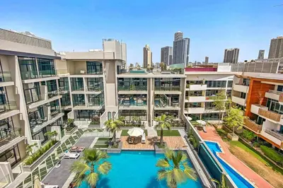 an aerial view of an apartment building with a swimming pool at Stylish Stay in the Heart of JVC in Dubai